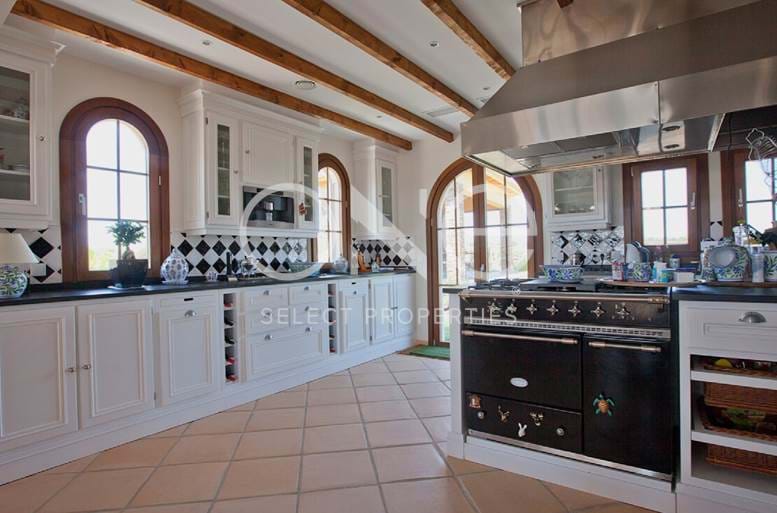 kitchen with central island and wooden ceiling beams